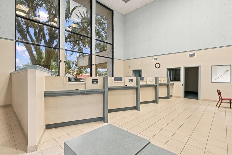 Lobby with tall windows and service counter at 101 Scholars Wy
