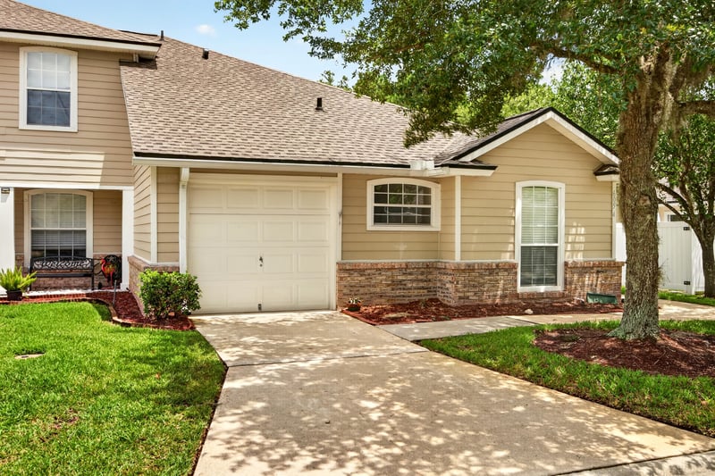 Front exterior view of the driveway and garage at 605 N Covered Bridge Rd, Jacksonville, FL