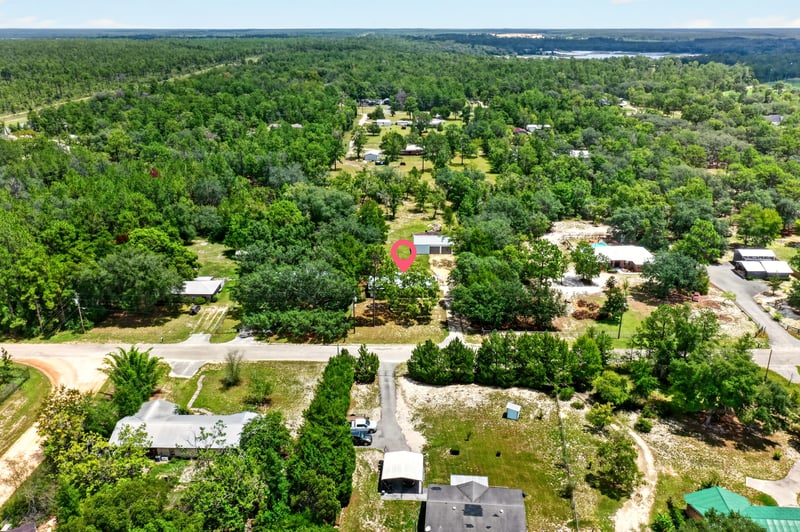 Aerial view of the home surrounded by wooded land at 6757 Deer Springs Rd, Keystone Heights, FL 32656