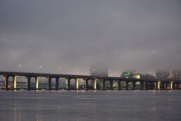 Bridge spanning the river under hazy sky in Jacksonville