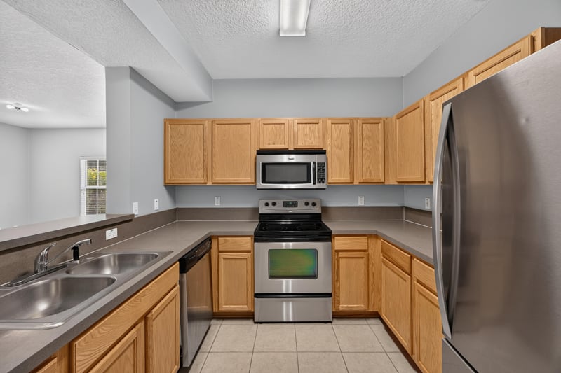 Kitchen with stainless range and refrigerator at 575 Oakleaf Plantation Pkwy, Orange Park, FL 32065