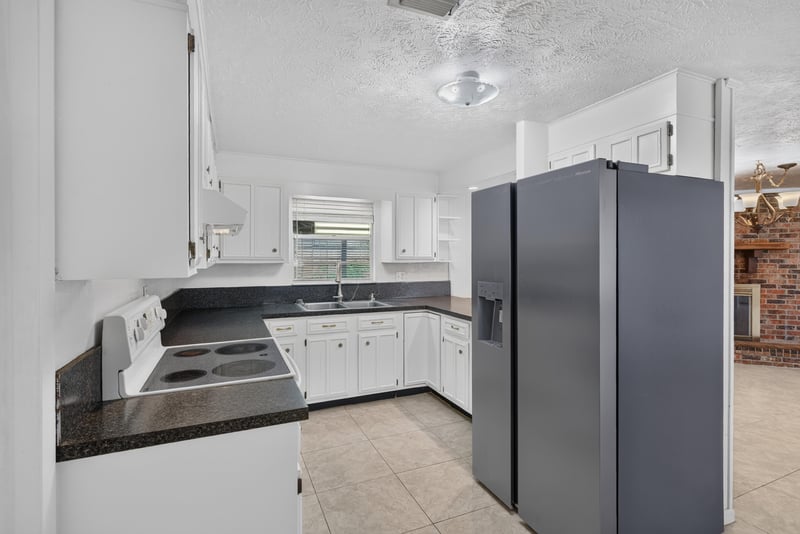 Kitchen with electric range and dark countertops at 9954 Larkdale Ct, Jacksonville, FL 32257