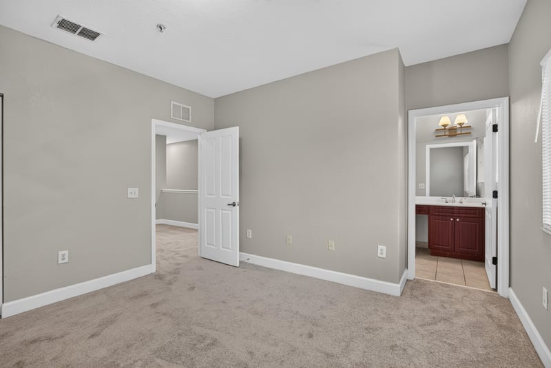 Bedroom with doorway to ensuite bathroom at 9745 Touchton Rd, Jacksonville, FL 32246
