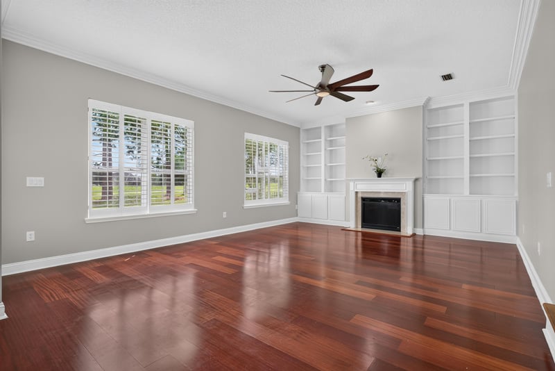 Family room with fireplace, built-ins and ceiling fan at 4109 Eagle Landing Pkwy, Orange Park, FL 32065
