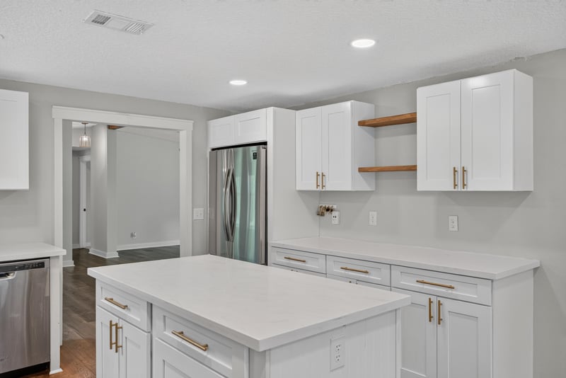 Kitchen view with refrigerator and white cabinetry at 4890 McAllister Rd, Middleburg, FL 32068