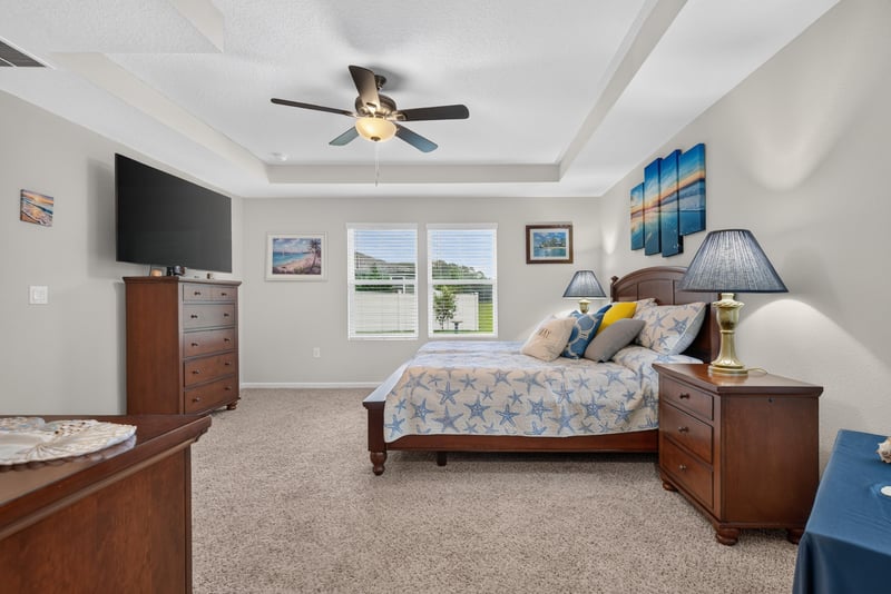 Primary bedroom with wall-mounted TV at 4319 Green River Pl, Middleburg, FL 32068