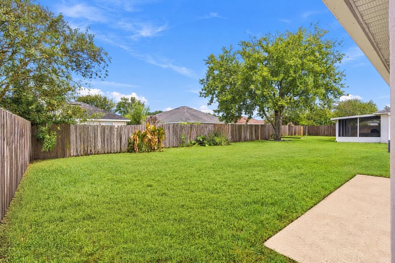 Backyard with fenced lawn and patio at 11197 Illford Dr