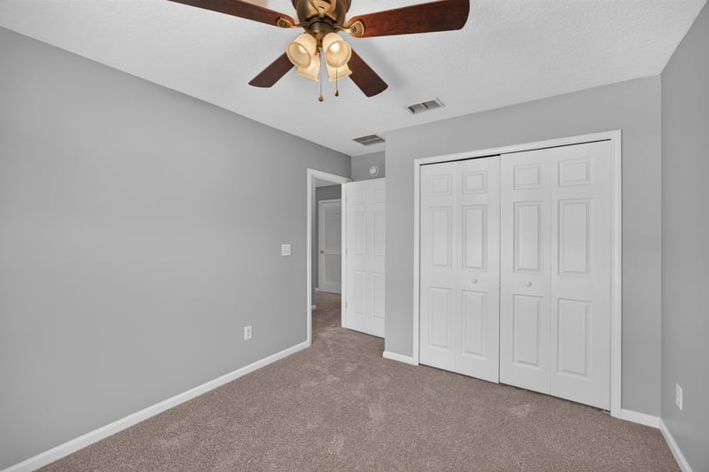 Bedroom with closet doors and ceiling fan at 470 Sparrow Branch Cir, Jacksonville, FL 32259