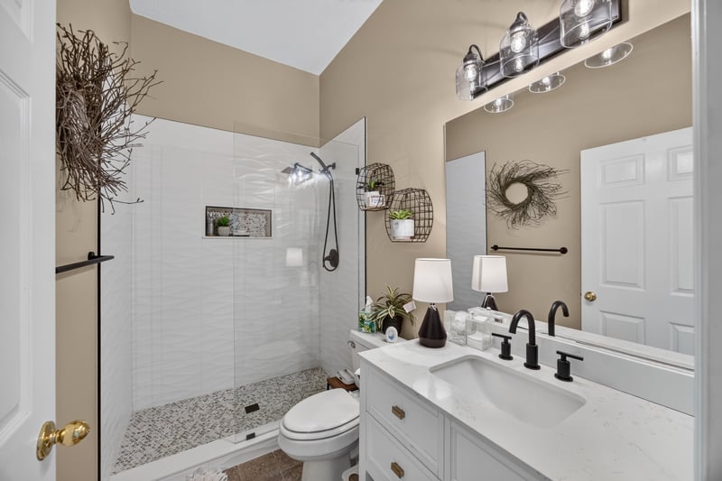 Bathroom with tub-shower combo and tile surround at 1820 Burgess Hill Dr E, Jacksonville, FL