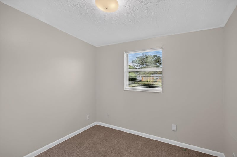 Carpeted bedroom with window at 87 Saratoga Cir S, Atlantic Beach, FL