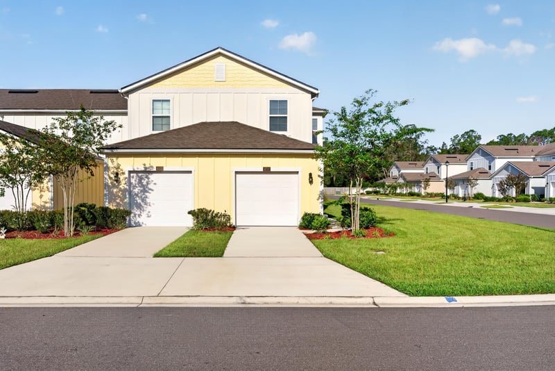 Front exterior view from driveway with manicured lawn at 4024 Bay Hawk Ct, Jacksonville, FL