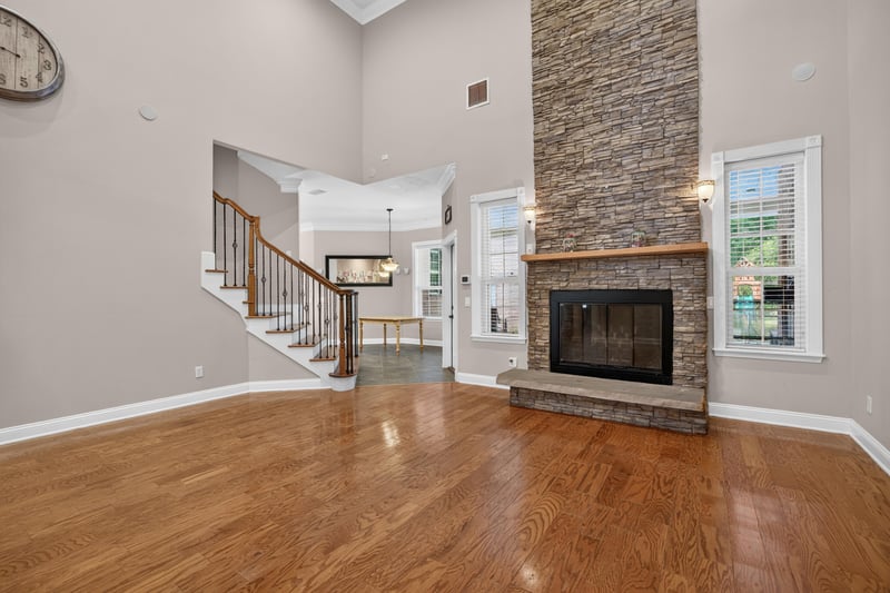 Great room with staircase and stone fireplace at 1735 Hagans Ridge Ct