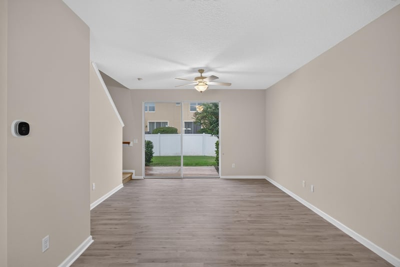 Living room with ceiling fan and sliding glass door at 3762 Hartsfield Forest Cir, Jacksonville, FL 32277