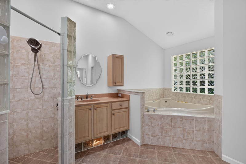 Primary bath shower with glass block detail at 11675 Magnolia Estates Rd, Jacksonville, FL 32223