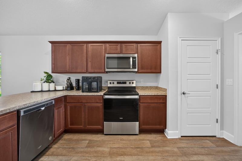 Kitchen with cherry cabinets and stainless range at 9846 Olivia St, Jacksonville, FL