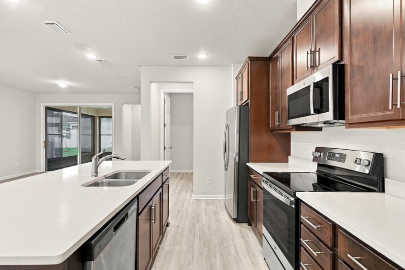 Kitchen with stainless range and sliding door at 7088 Mahogany Run Dr, Jacksonville, FL 32244