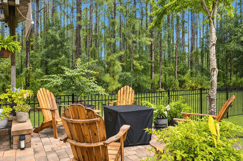 Backyard with adirondack chairs and fence at 10923 Black Diamond Ct, Jacksonville, FL