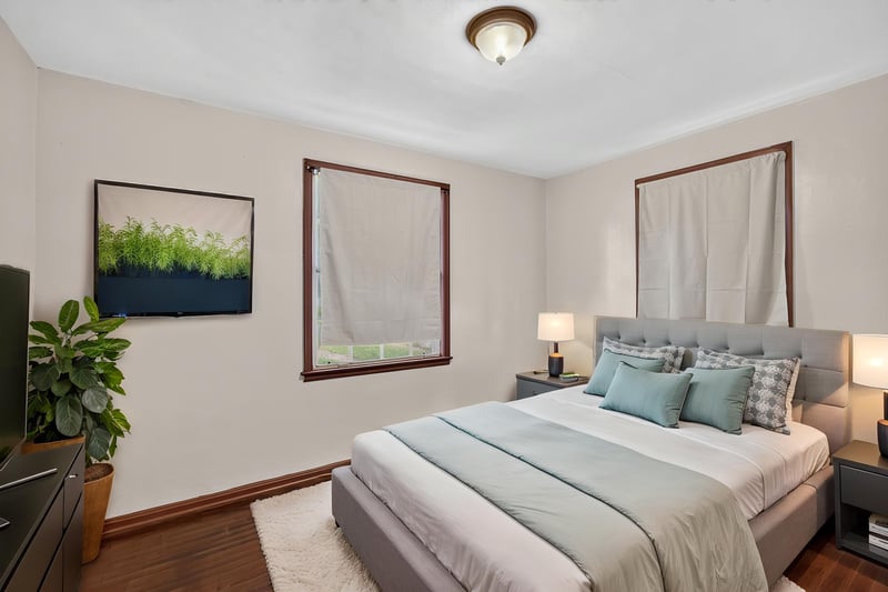Bedroom staged with teal bedding and plant at 2132 Allandale Cir W, Jacksonville, FL