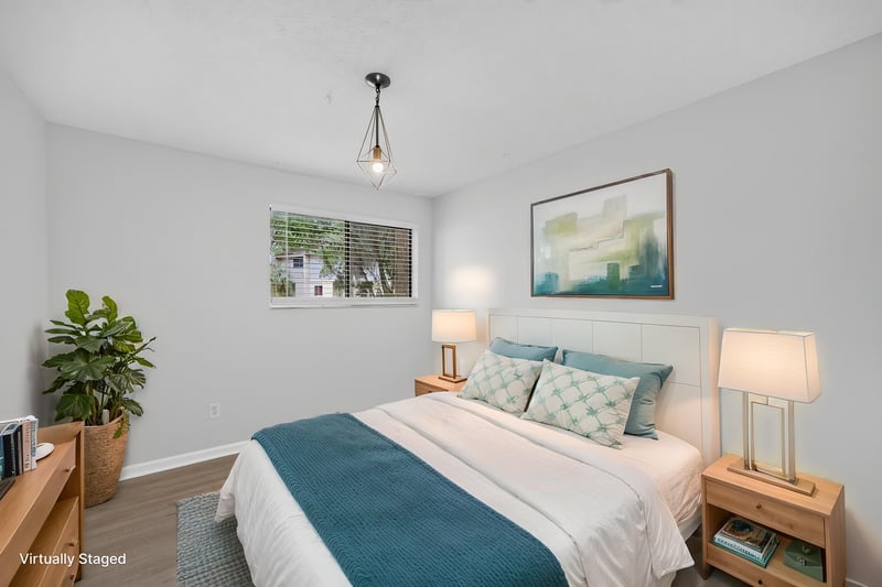 Primary bedroom with bed and nightstand, virtually staged, at 3801 Crown Point Rd unit 2061, Jacksonville, FL 32257