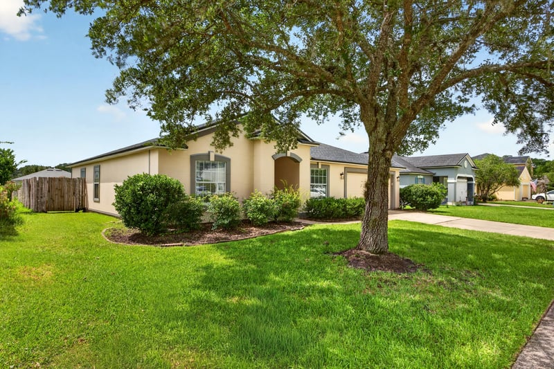 Front exterior with shade tree and lawn at 2065 Creekmont Dr