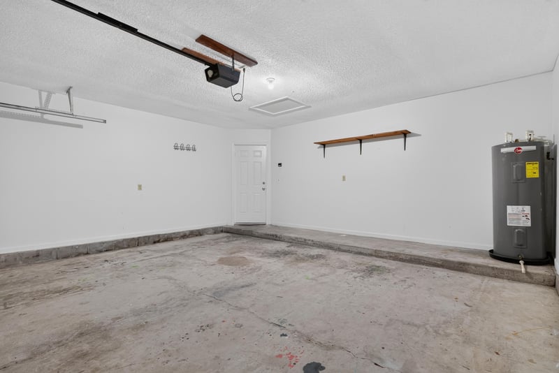 Garage interior with tankless water heater at 4427 Millstone Ct, Jacksonville, FL