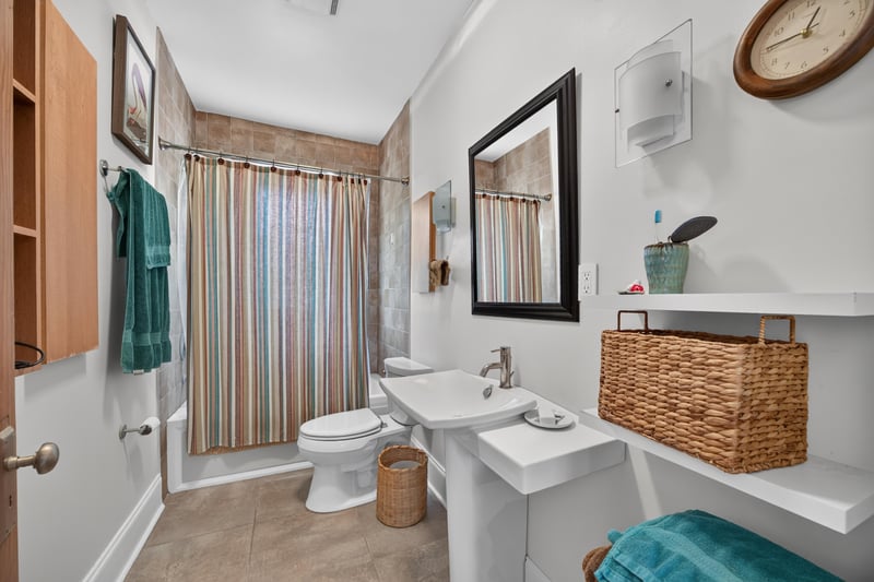 Bedroom with patterned curtains and an orange bedspread at 1555 Belmonte Ave, Jacksonville, FL 32207