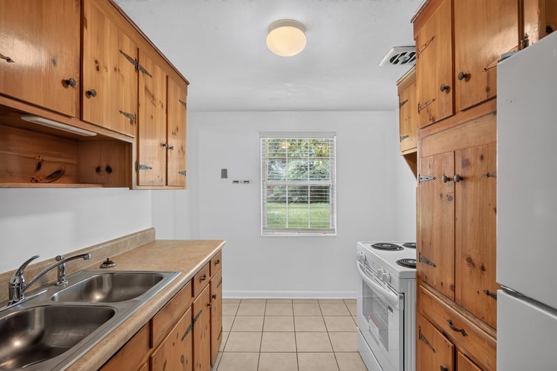 Kitchen with wood cabinets and window over sink at 5812 Tampico Rd, Jacksonville, FL 32244