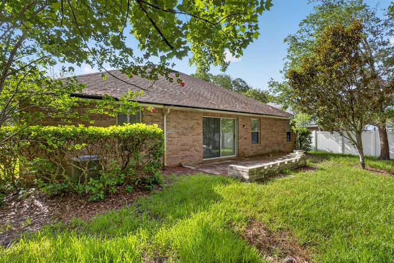 Backyard lawn with mature trees at 299 John's Creek Pkwy, St. Augustine, FL 32092