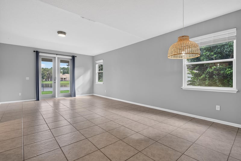 Living room with pendant light and tile floor at 13685 Goodson Pl, Jacksonville, FL 32226