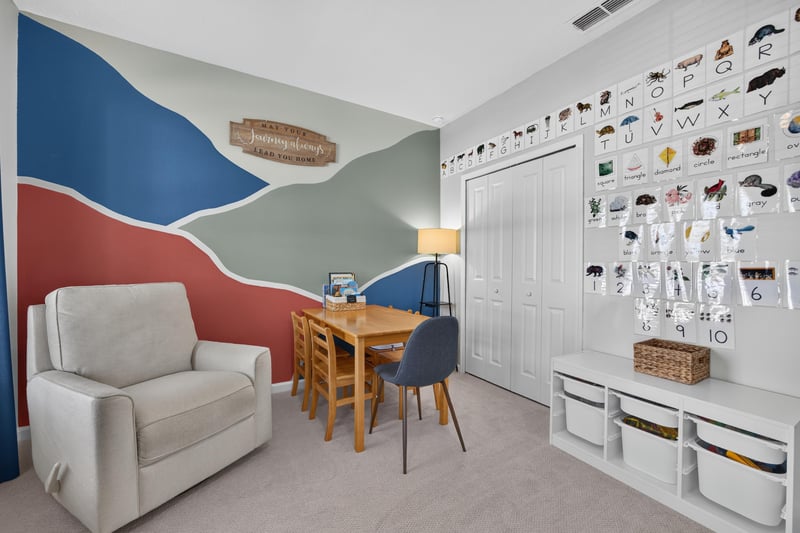 Bedroom with mountain mural and reading chair at 2354 Jennings Farm Dr, Middleburg, FL 32068