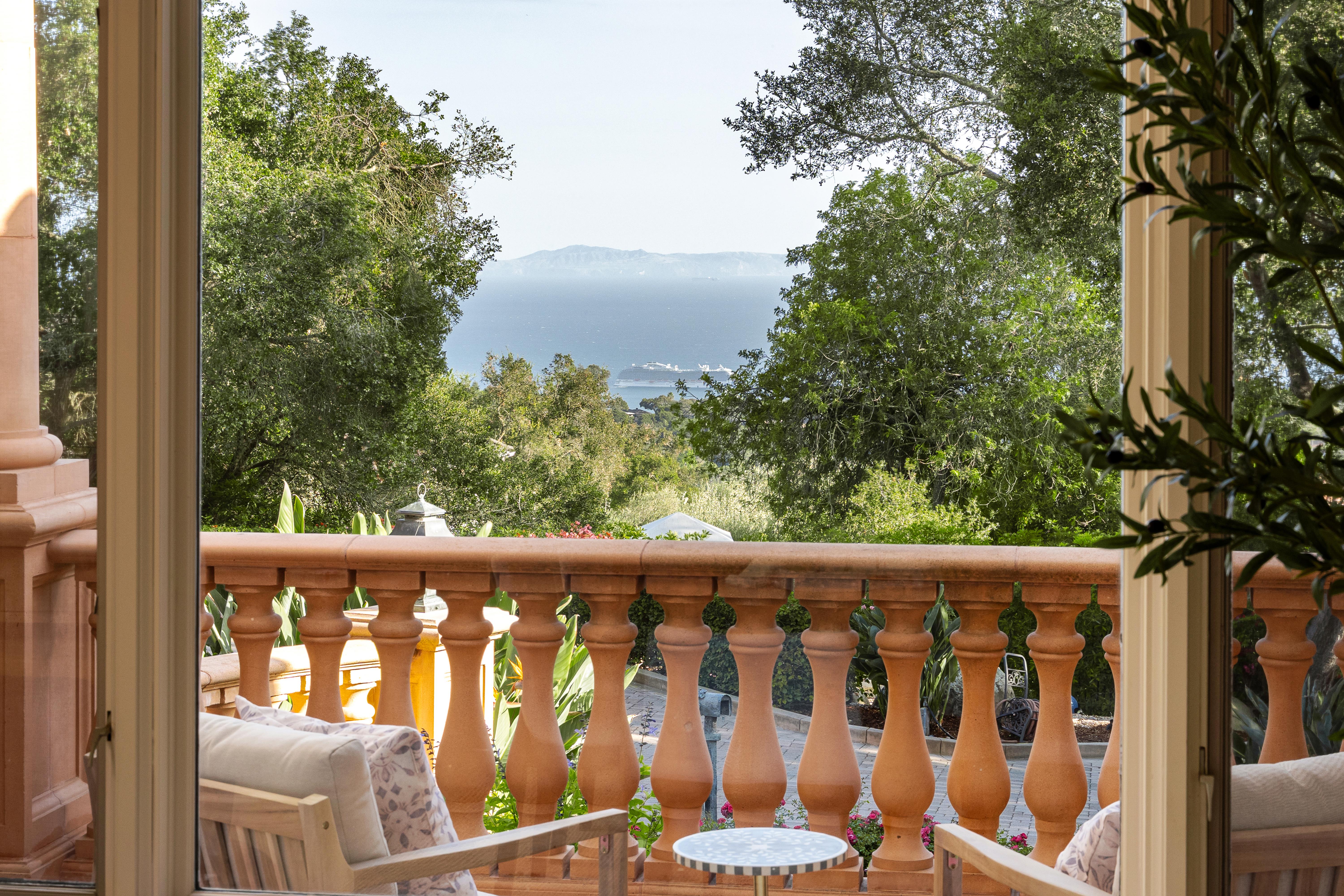 Twilight photography of estate exterior at 450 El Cielito Rd, Santa Barbara — virtual tour photography and twilight imaging capturing warm interior light against a violet Pacific sky above the American Riviera. Our team captured still photography, aerial drone photography, twilight photography, a Matterport virtual tour, a 2D floor plan, and a custom property website from afternoon through twilight.