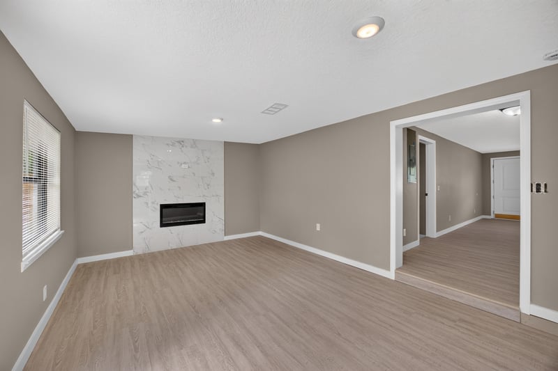 Empty room with fireplace and open doorway at 184 Draco St, Orange Park, FL 32073