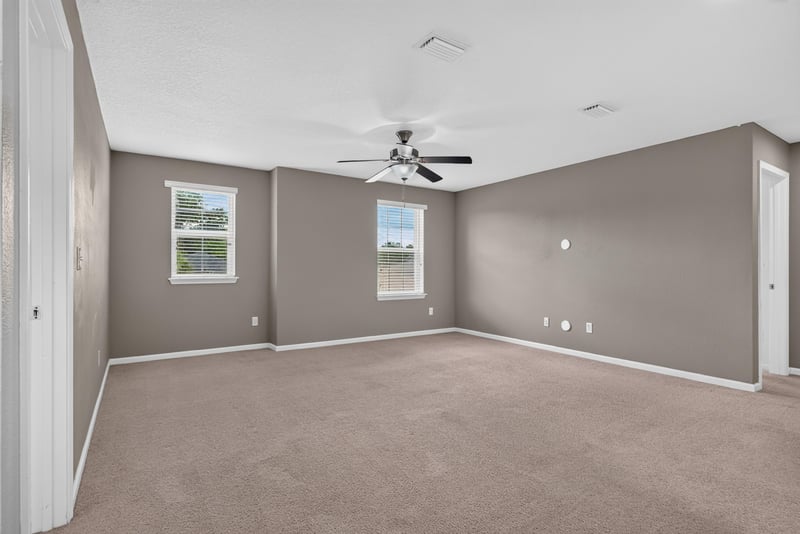 Living room with carpet, ceiling fan and windows at 263 Gilmore Ln, Orange Park, FL 32065