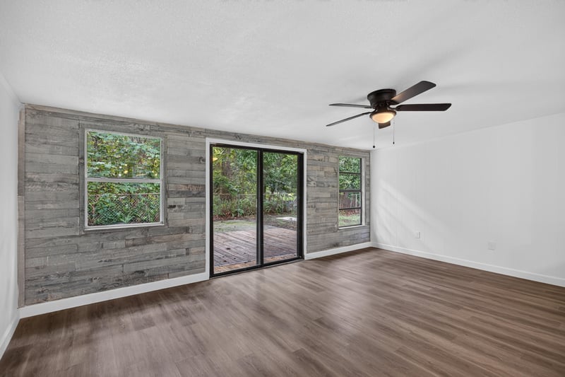 Living room with sliding glass door to backyard at 3113 Kline Rd, Jacksonville, FL 32246