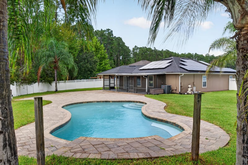 Backyard pool with roof solar panels at 706 Grampian Highlands Dr, St. Johns, FL 32259
