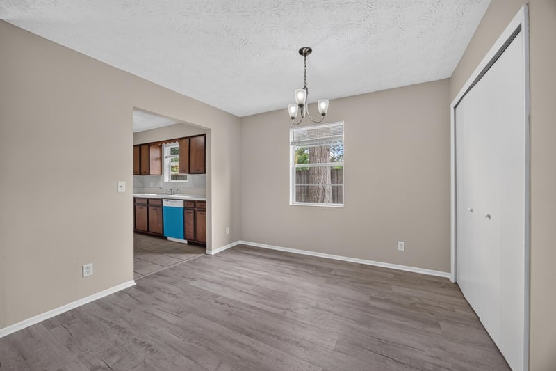 Dining area open to kitchen with pendant light fixture at 1083 Stokes St, Jacksonville, FL