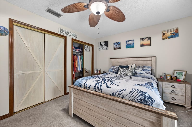 Bedroom with barn door closet and ceiling fan at 981 Marble Ridge Dr, Orange Park, FL 32065