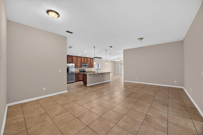 Open kitchen and living area with tile floor at 469 Glendale Ln, Orange Park, FL