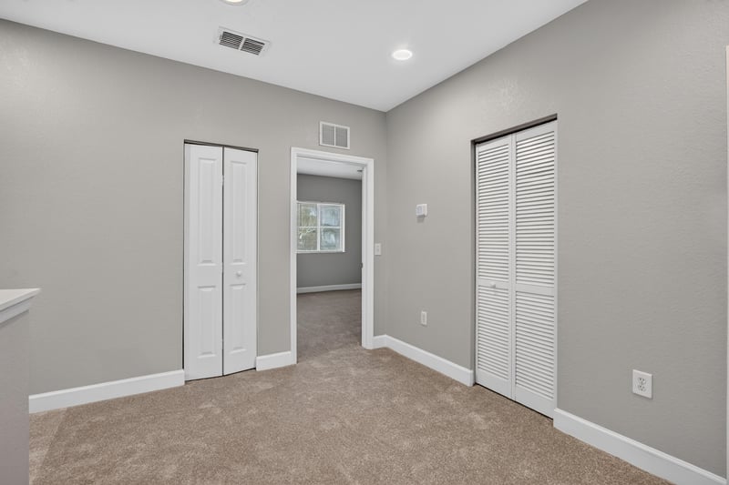 Carpeted hallway with closet doors at 9745 Touchton Rd, Jacksonville, FL 32246