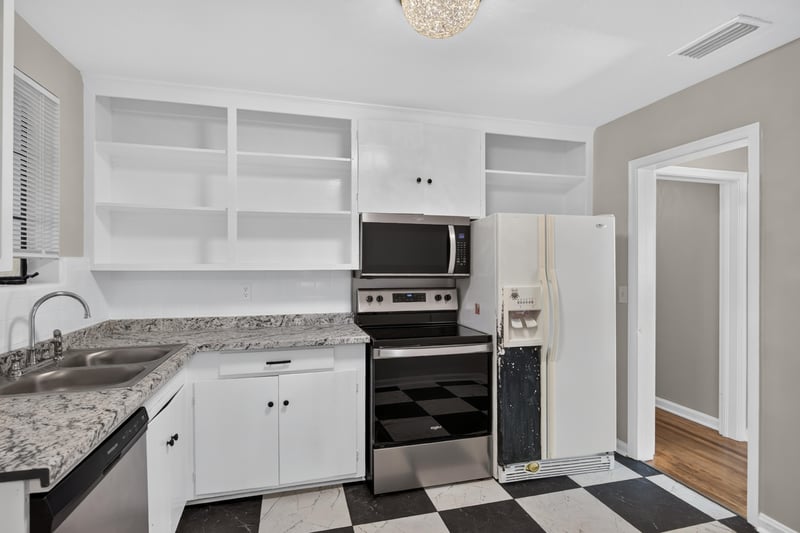 Kitchen with stainless appliances and built-in shelving at 6338 Mercer Cir W, Jacksonville, FL