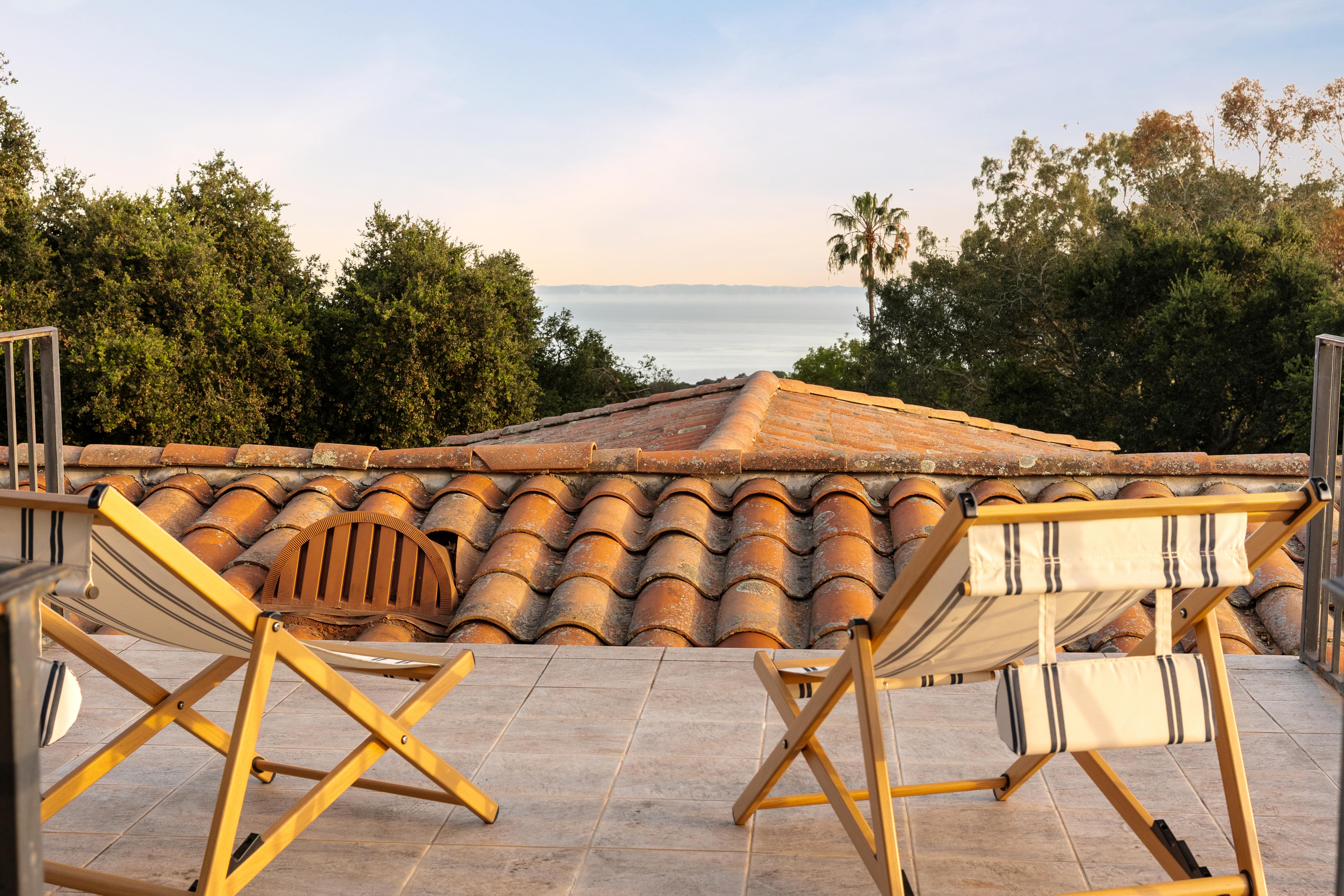Aerial drone photography of hillside property grounds at 450 El Cielito Rd, Santa Barbara — real estate drone photography documenting terraced outdoor spaces, pool, and Santa Ynez Mountain backdrop along the Southern California coast. Our team captured still photography, aerial drone photography, twilight photography, a Matterport virtual tour, a 2D floor plan, and a custom property website from afternoon through twilight.