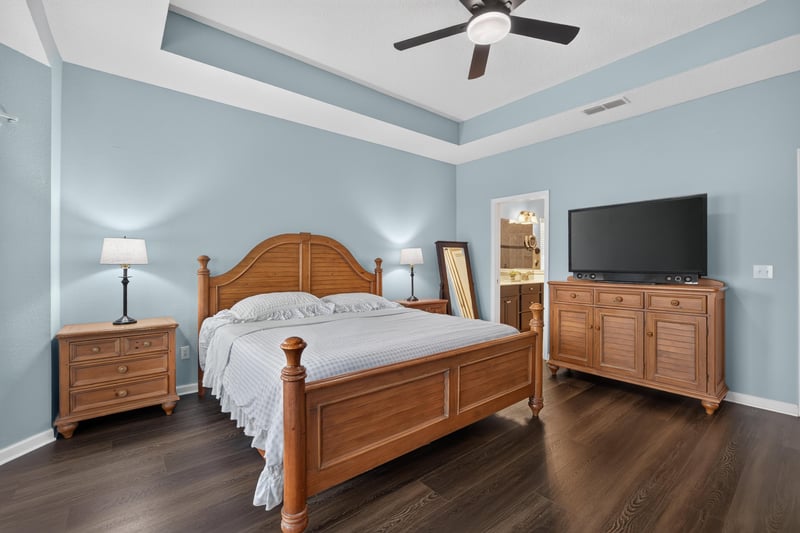 Primary bedroom with wood furniture and tray ceiling at 538 Porta Rosa Circle, St. Augustine, FL 32092