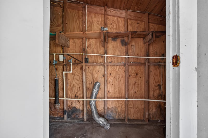 Utility nook with wood paneling and exposed plumbing at 4030 Leonard Cir W, Jacksonville, FL 32209