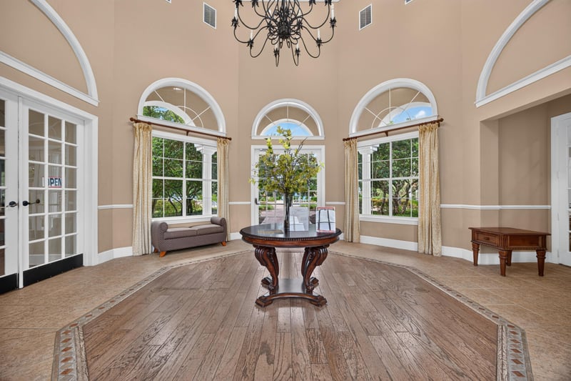 Clubhouse entry with arched windows and chandelier in Mirabella Condo