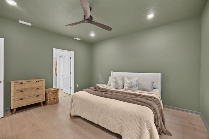 Primary bedroom with dresser and two windows at 93 Lochloosa Ct, St. Johns, FL 32259