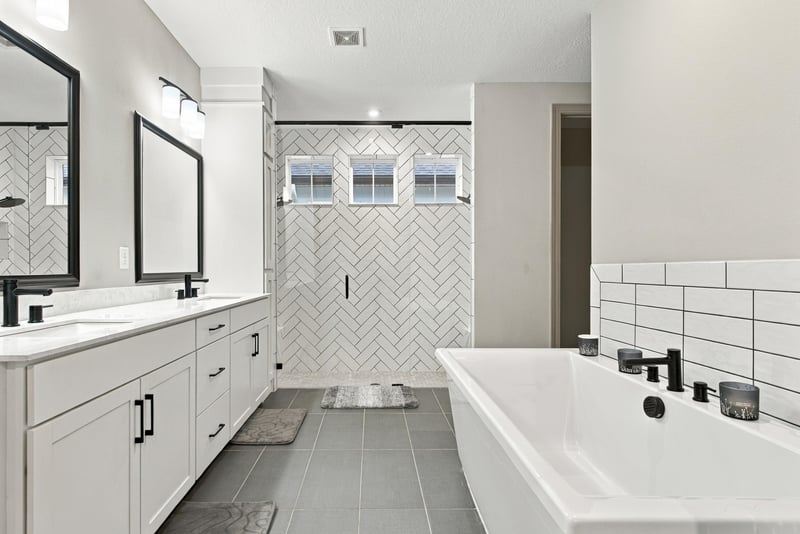 Primary bathroom with soaking tub and tile accent wall at 3921 Spyglass Hill Ln