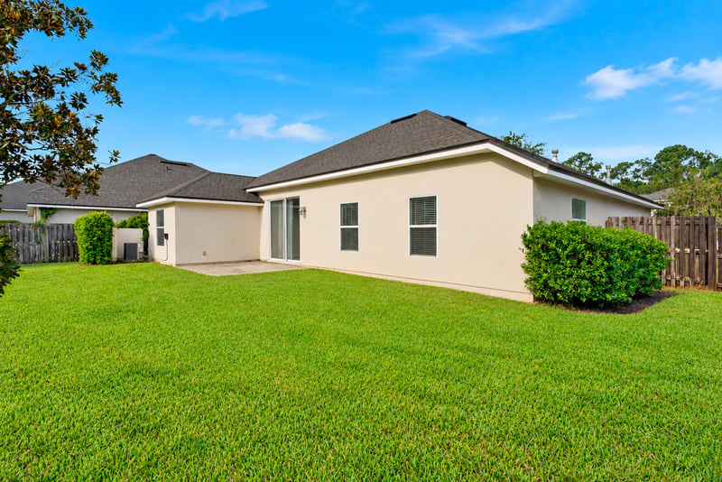 Backyard view with grass lawn and fence at 14187 Big Spring St, Jacksonville, FL 32258