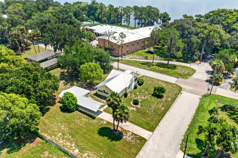 Drone neighborhood view with tree canopy in Crescent City, FL