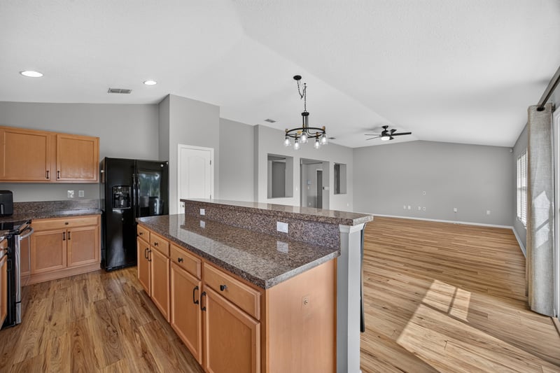 Kitchen opening to carpeted room at 7545 Lirope St, Jacksonville, FL 32244
