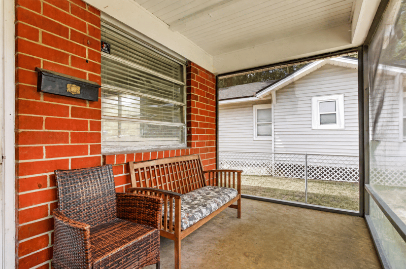 Screened porch with seating area at 450 E 46th St, Jacksonville, FL 32208